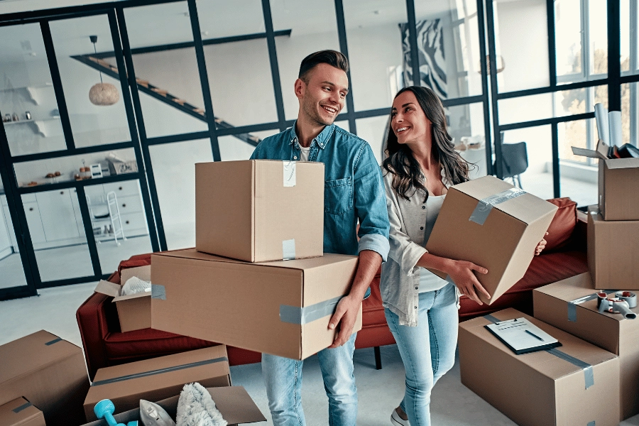 couple moving in together and holding boxes 